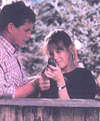 Gary teaches Cathy how to shoot